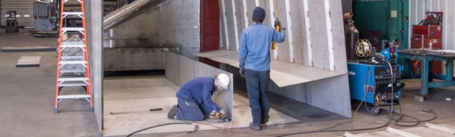 Metal Fabricators working in shop.