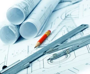 Closeup of blueprints with a pencil lying on top