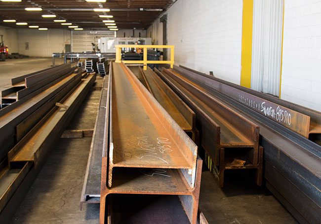 Large collection of structural steel beams ready for a new fabrication project.