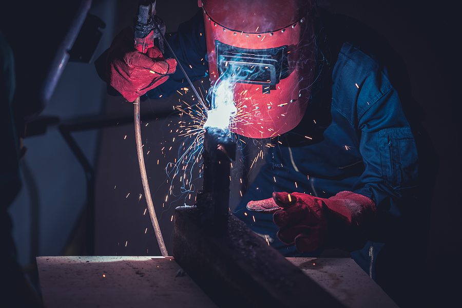 Metal fabricator working on a custom project in a fabrication shop.