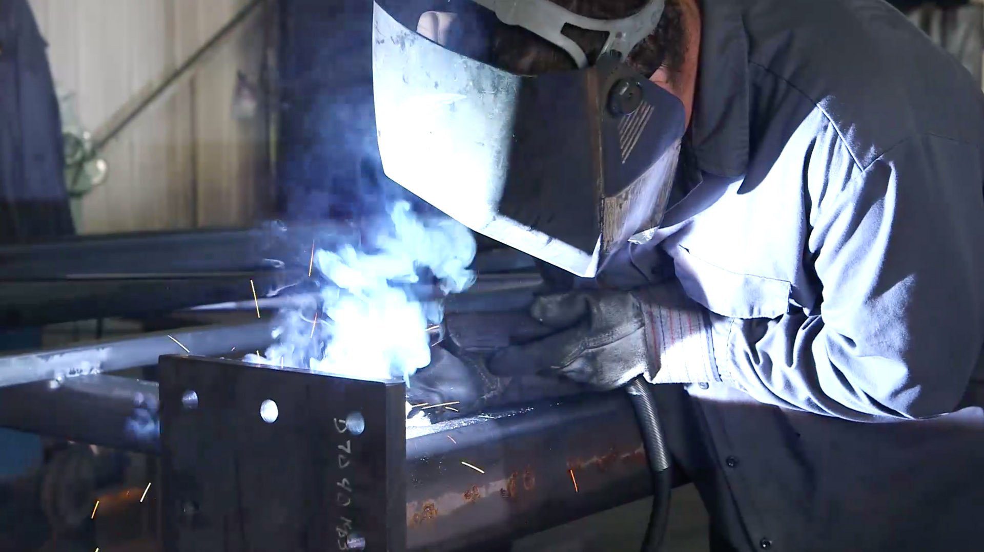 welding-vid2.jpg Welder working on steel frame.