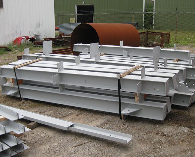Powder coated structural steel beams waiting to be installed.