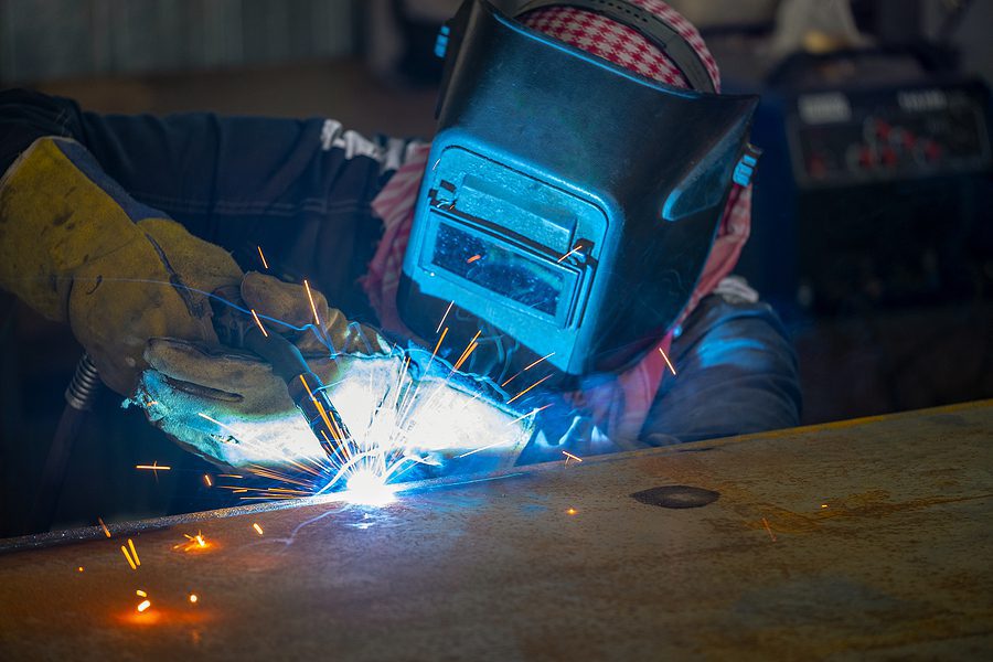 Welder performing working on structural steel.