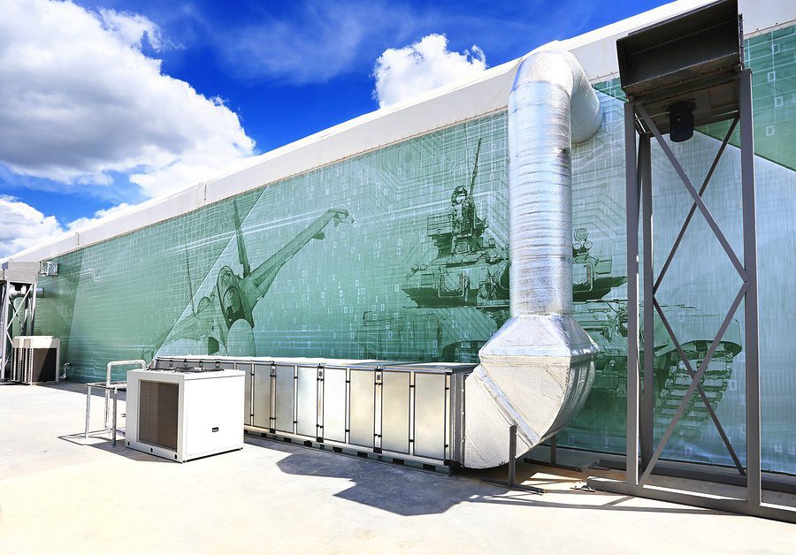 Large ductwork compliments mural painted on side of building behind it.
